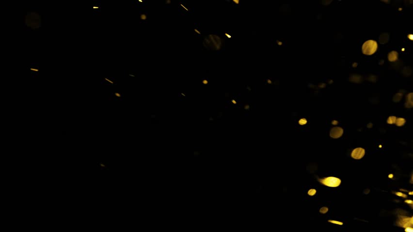 Golden particles moving in slow motion on black background 4k footage, Gold litters footage, particles moving footage, gold glitters footage, particles explosion. Animation video transparent backgroun