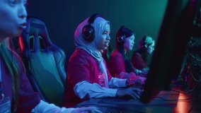 Medium shot of joyous multinational female cybersport team members giving each other high fives and cheering, after successfully passing level in online multiplayer shooter game - Powered by Shutterstock - Get 15% off with code: PIKWIZARD15