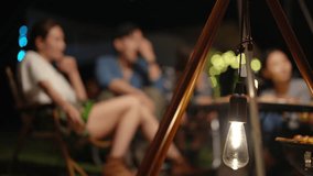 Happy Asian man and woman camping having dinner and talking together in forest mountain at night. People friends enjoy outdoor active lifestyle travel nature, hiking and camping on summer vacation. - Powered by Shutterstock - Get 15% off with code: PIKWIZARD15