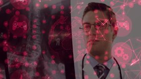 Doctor holding chest X-ray film analyzing medical data while red medical icon overlay intensifying. Medical, technology, futuristic, healthcare, innovation, visualization, diagnostic - Powered by Shutterstock - Get 15% off with code: PIKWIZARD15