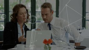 Woman tapping laptop keyboard igniting tech overlays while male colleague analyzing chart at café. Collaboration, innovation, communication, contemporary, professional, digital, business - Powered by Shutterstock - Get 15% off with code: PIKWIZARD15