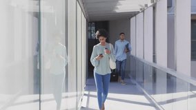 Entering corridor, woman walking scrolling phone, timeline bar-line charts showing business growth. Modern, professional, technology, data, analytics, collaboration, urban - Powered by Shutterstock - Get 15% off with code: PIKWIZARD15