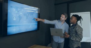 Two analysts tapping laptop and pointing digital map, adjusting timeline for tech trend analysis. Technology, collaboration, futurism, data visualization, corporate, professional, innovation - Powered by Shutterstock - Get 15% off with code: PIKWIZARD15