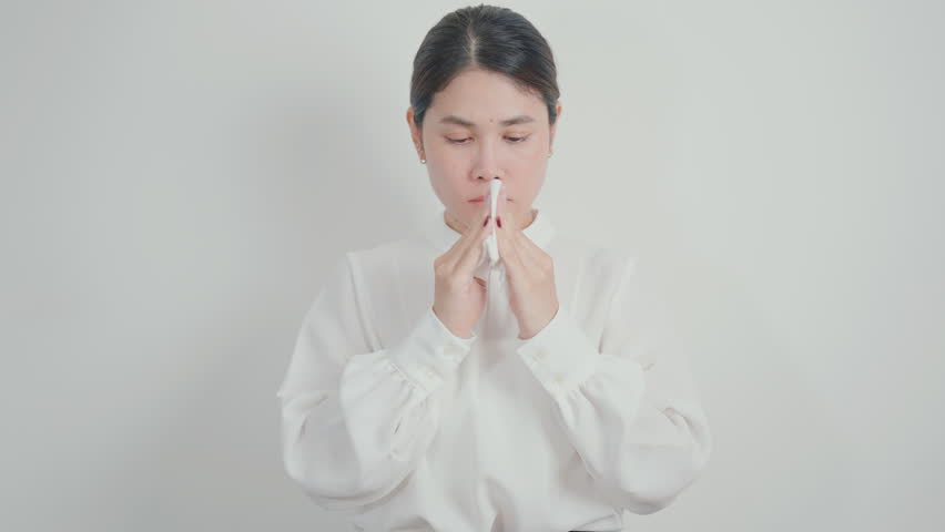 business woman blowing her nose with tissue for concepts of Common Cold, Influenza, Flu, Hay, Fever, Covid 19, Respiratory Infection, Sinusitis, Allergic Rhinitis, Allergy, Medical and health care