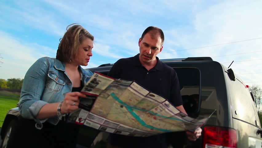 A lost couple argue while looking at a map.
