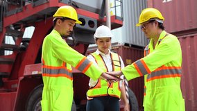 group of diversity asian industrial team stacks hands celebrates success with high-fives together at a container port. strong teamwork unity trust and commitment in a global logistics and shipping - Powered by Shutterstock - Get 15% off with code: PIKWIZARD15