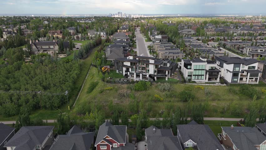 Aerial view of suburban neighbourhood of Aspen Estates in Calgary on a stormy summer evening. 