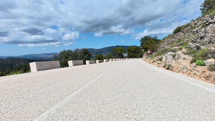 A Serene and Picturesque Mountain Road Featuring Stunning Scenic Views All Around You