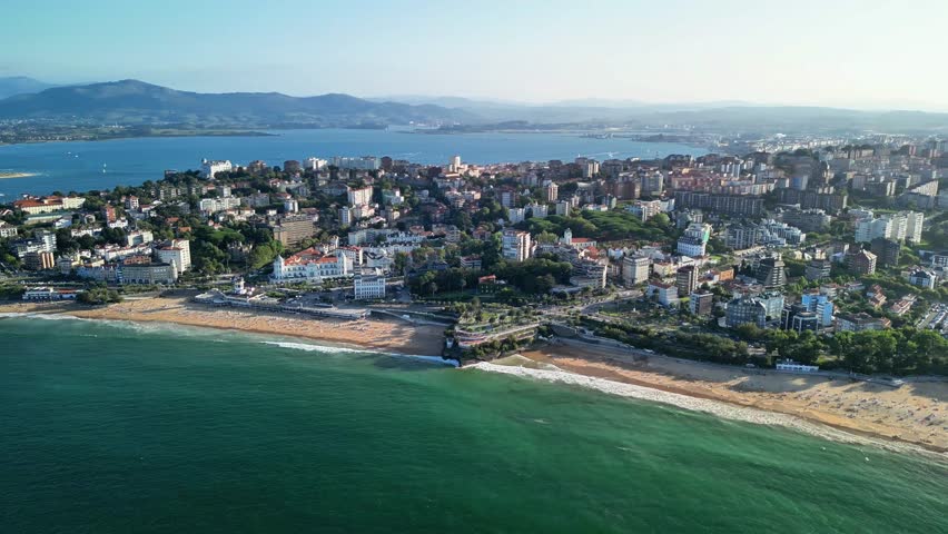 A Stunning Aerial View of a Beautiful Coastal Town Featuring Beaches and Majestic Mountains