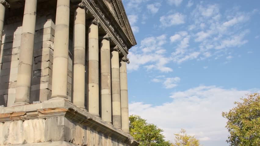 Happy tourist blogger sightseeing explore enjoy famous roman The Garni Temple - classical colonnaded structure