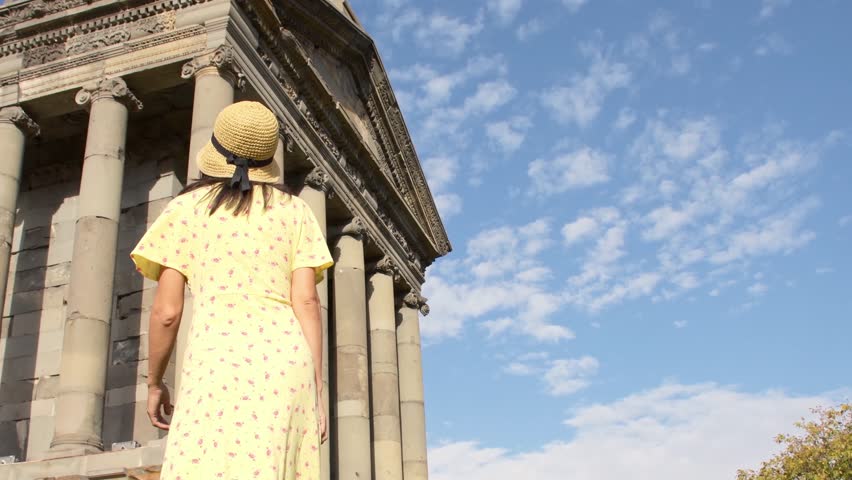 Happy tourist blogger sightseeing explore enjoy famous roman The Garni Temple - classical colonnaded structure