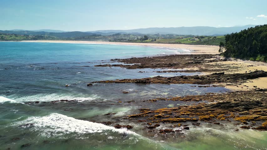 Stunning and Beautiful Coastal Landscape Featuring a Rocky Shoreline and Sparkling Clear Water