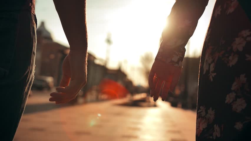 Love couple holding hands on city sunset background. Close up silhouette man woman touching hands together at sunrise street. Romantic couple couple holding each other hand's enjoying romantic date