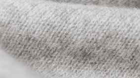 Macro shot reveals tactile fibers and knit pattern of grey folded blanket - Powered by Shutterstock - Get 15% off with code: PIKWIZARD15