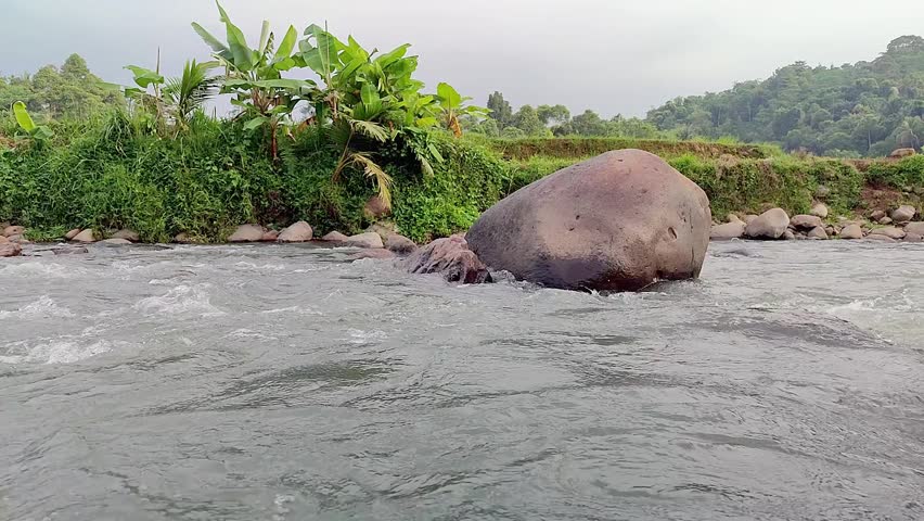 An aesthetic structure of stones in a river with strong stream.