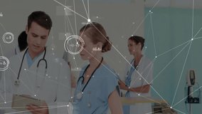 Doctor scrolling tablet and nurse pointing medical data overlays while reviewing data in corridor. Clinical collaboration, digital health, medical technology, futuristic healthcare, professional - Powered by Shutterstock - Get 15% off with code: PIKWIZARD15
