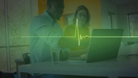 Two colleagues pointing laptop screen while neon ECG line sweeping left guiding health discussion. Collaboration, teamwork, technology, innovation, office, corporate, modern - Powered by Shutterstock - Get 15% off with code: PIKWIZARD15