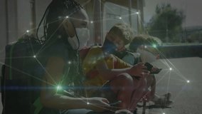 Students tapping devices on schoolyard bench showing network connection around heads and hands. Technology, connectivity, youth, education, digital, communication, outdoor - Powered by Shutterstock - Get 15% off with code: PIKWIZARD15