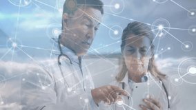 Male doctor tapping network node while female doctor scrolling tablet, reviewing medical data. Healthcare, telemedicine, digital, innovation, collaboration, diagnostics, technology - Powered by Shutterstock - Get 15% off with code: PIKWIZARD15