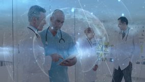 Senior doctor and clinician pointing tablet while nurse tapping medical globe upon nurse entering. Medical teamwork, digital health, healthcare technology, professional collaboration, hospital - Powered by Shutterstock - Get 15% off with code: PIKWIZARD15