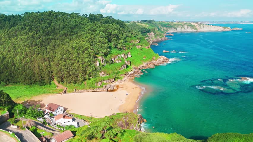 Amazing Playa de La Nora beach near Gijon, Asturias, northern Spain. Aerial view of the idyllic white sand beach with turquoise sea water along the Cantabrian Sea coast of Asturias.