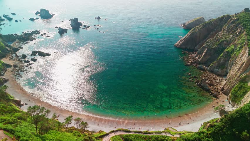 Aerial view of Playa del Silencio o Gaviero in Cudillero, Asturias, Spain. Stunning wild beach with crystal-clear water, dramatic rocky cliffs, and unspoiled nature on the northern Spanish coast.