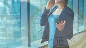 Woman starting smartphone call beside floor-to-ceiling window, clock overlay tracking business call. Corporate, communication, modern, professional, urban, productivity, technology - Powered by Shutterstock - Get 15% off with code: PIKWIZARD15