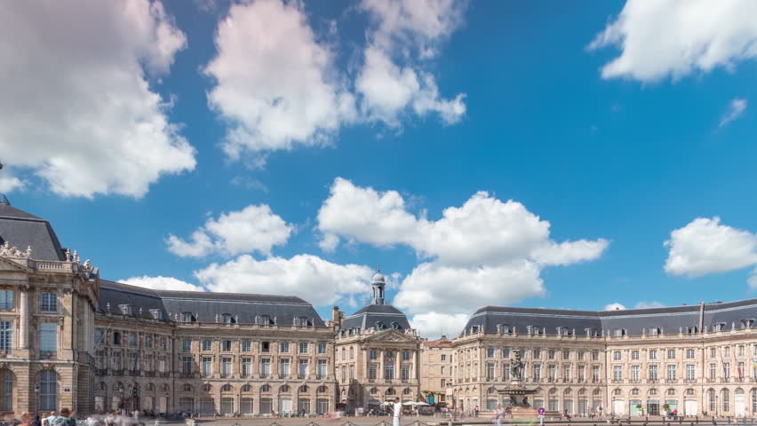 Place de la Bourse hyperlapse in Bordeaux, France, reflecting historic architecture. Tourists enjoy the landmark and the fountain. Timelapse of traffic and tram passing by.