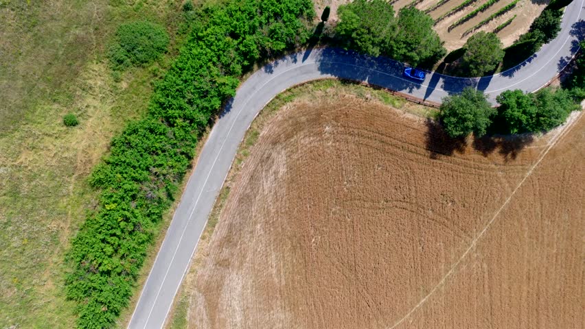 Aerial view of a police car on the curves of the roads of Tuscany. Italy.
The patrol of the police force that controls the territory.
