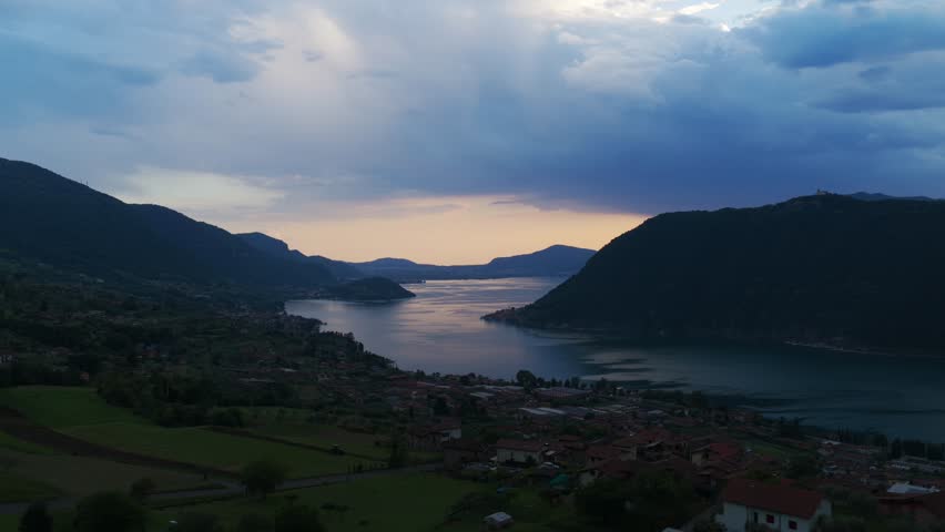Aerial view of Lake Iseo at sunset with Monte Isola and the town of Marone, Italy