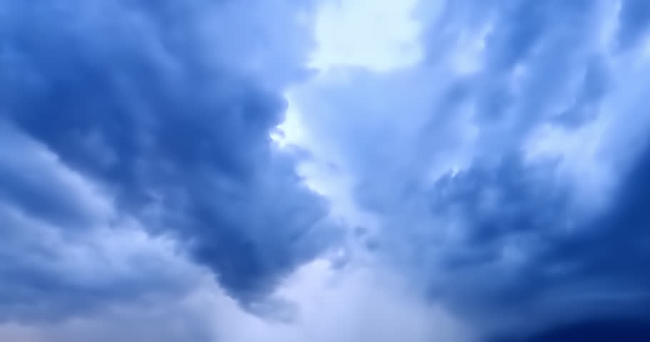 Time-lapse footage reveals fast-shifting storm clouds and rainfall moving rapidly over a vast open field, emphasizing raw natural energy, atmospheric transitions, and dramatic sky movement.