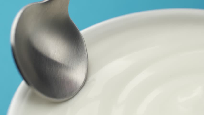 Spoon and natural yogurt texture, macro, concept video for commercial