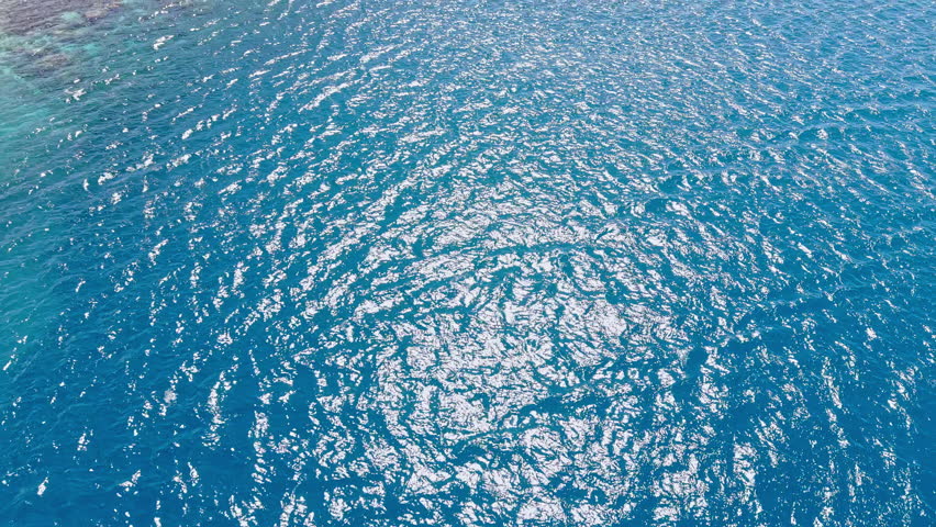 Bora Bora, French Polynesia. Flying Above Lagoon, Coral Reefs and Green Hills of Main Island, Revealing Drone Shot