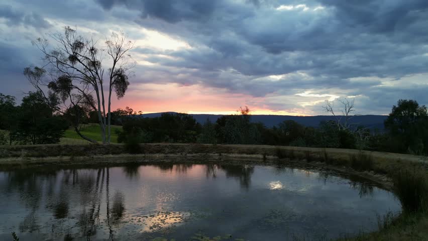 Looking at lake reflection of sunset on a dark and moody evening