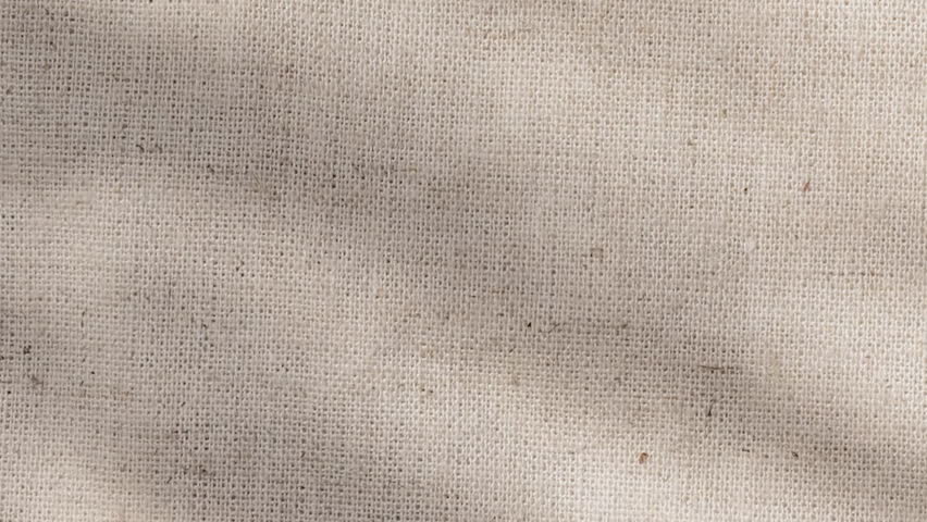 Detailed shot of canvas linen weave catching sunlight on textured surface