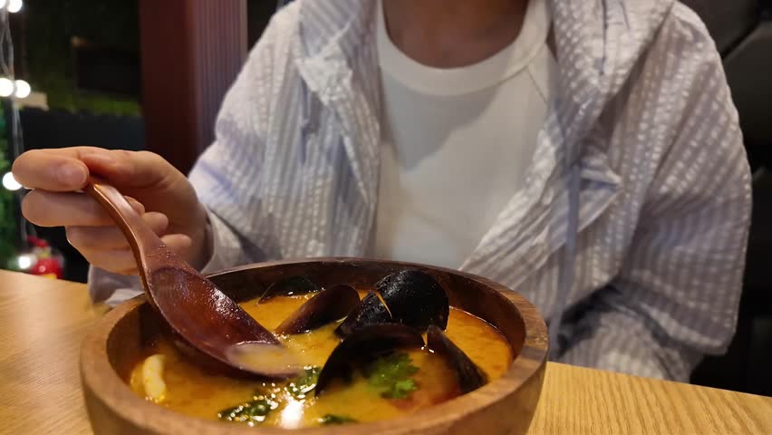 Girl eats Tom Yum without showing her face