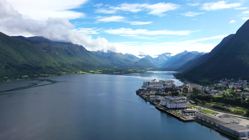 Explore breathtaking fjord landscapes in Norway showcasing crystal-clear waters and towering mountains during a bright summer day