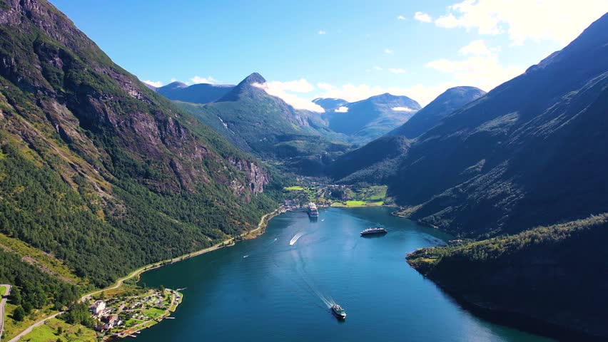 Explore breathtaking fjord landscapes in Norway showcasing crystal-clear waters and towering mountains during a bright summer day