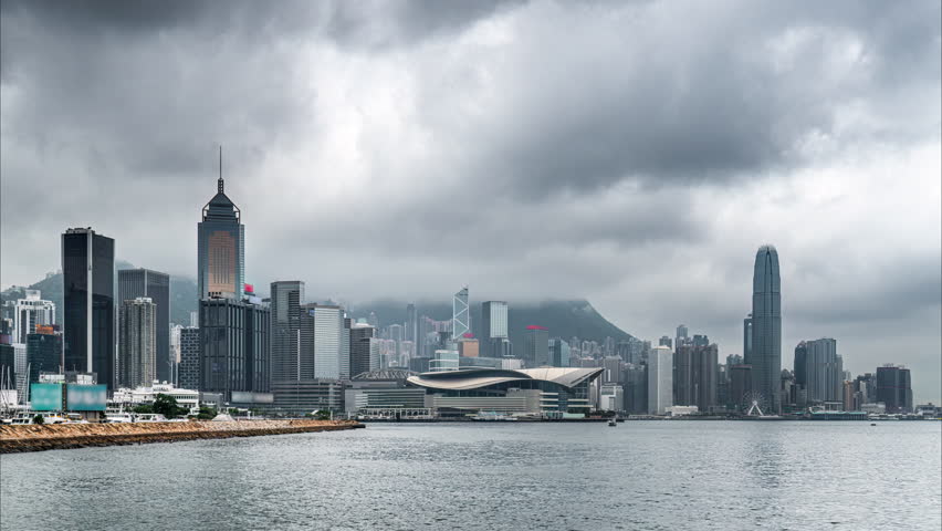 Time lapse of clouds moving over skyscrapers and Hong Kong Convention and Exhibition Centre in Wan Chai