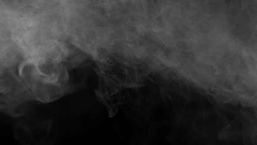 A heavy, dense cloud of white smoke or fog rolls slowly from the top left corner, creating a thick, atmospheric texture on a black background