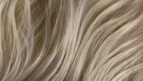 Closeup blond hair texture, slow motion of female hand combing long curly hair - Powered by Shutterstock - Get 15% off with code: PIKWIZARD15