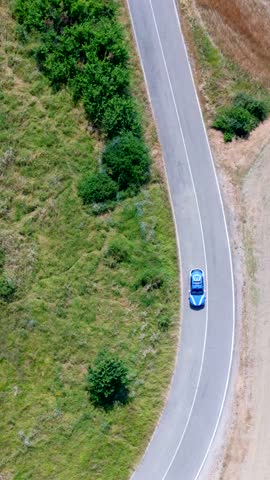 Aerial view of a police car on the curves of the roads of Tuscany. Italy.
The patrol of the police force that controls the territory.
