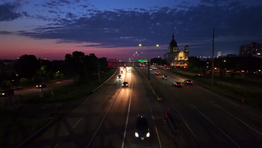 City highway traffic lights at night with illuminated St Paul Cathedral in the background in Saint Paul, Minnesota