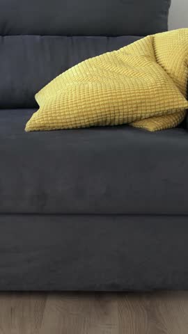 Tired frustrated millennial man at home, thinking over problems, feeling stress, fatigue and suffering from headache. Sadness and unhappy life. Cheerless sad depressed man lying on sofa over a cushion