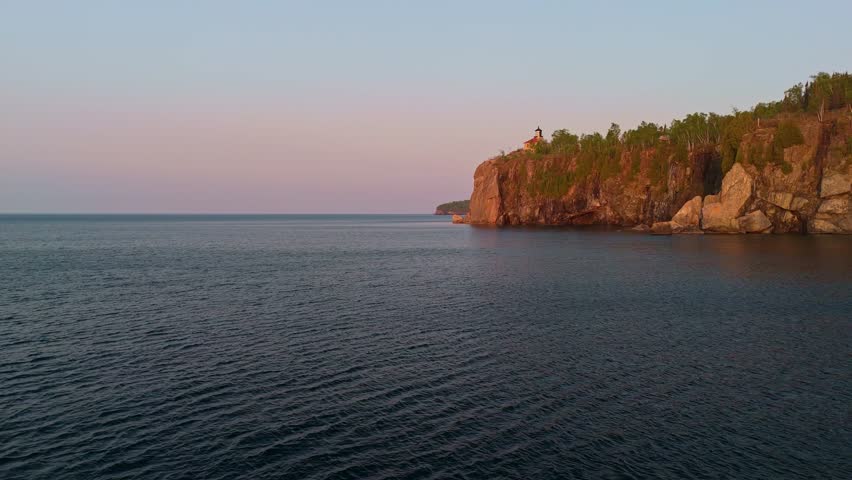 Breathtaking sunrise illuminating the historic Split Rock Lighthouse on Lake Superior