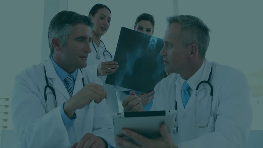 Doctor tapping tablet and explaining Xray while merging binary records for analysis. Medical team, digital health, collaboration, clinical analysis, healthcare technology, professional consultation, - Powered by Shutterstock - Get 15% off with code: PIKWIZARD15