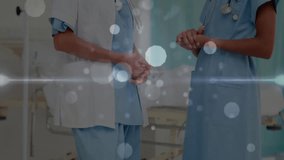Doctor initiating discussion gesturing beside bed teal curtain, nurse listening nodding with bokeh. Medical staff, collaboration, clinical teamwork, professional relationship, healthcare environment, - Powered by Shutterstock - Get 15% off with code: PIKWIZARD15
