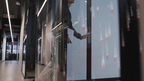 Staff holding portfolio walking hall initiating binary overlay opening glass door entering office. Technology, innovation, professionalism, corporate, futuristic, digital, business - Powered by Shutterstock - Get 15% off with code: PIKWIZARD15