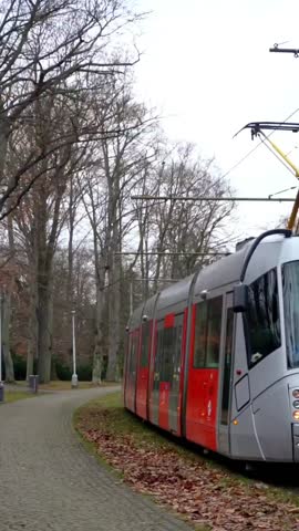 red tram rides on rails in Prague