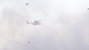 Rescue helicopter spraying water over rooftops - Powered by Shutterstock - Get 15% off with code: PIKWIZARD15